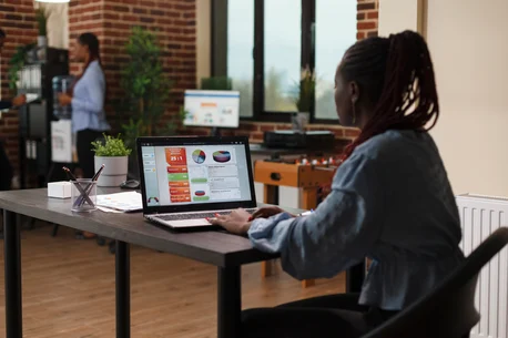 picture of woman working with graphs on laptop